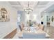 Dining room with coffered ceiling, chandelier, table set for a meal, and neutral tones at 4824 Sultana Sw Way, Atlanta, GA 30331