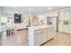 Open-concept kitchen with a large island, stainless steel appliances, and a staircase in the background at 4824 Sultana Sw Way, Atlanta, GA 30331