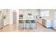 Stylish kitchen features white cabinets, stainless steel appliances, and a granite-topped center island with seating at 4824 Sultana Sw Way, Atlanta, GA 30331