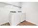 The laundry room has a side-by-side washer and dryer with wood-look flooring at 4824 Sultana Sw Way, Atlanta, GA 30331