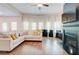 Bright living room features hardwood floors, a large sectional, fireplace, and abundant natural light at 4824 Sultana Sw Way, Atlanta, GA 30331