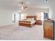 Spacious main bedroom featuring carpet flooring, a ceiling fan, and ample natural light at 4824 Sultana Sw Way, Atlanta, GA 30331