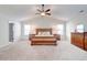 Spacious main bedroom featuring carpet flooring, a ceiling fan, and ample natural light at 4824 Sultana Sw Way, Atlanta, GA 30331