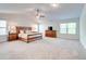 Spacious main bedroom featuring carpet flooring, a ceiling fan, and ample natural light at 4824 Sultana Sw Way, Atlanta, GA 30331