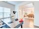 Bright office space with a large desk, natural light, and a view into the dining room at 4824 Sultana Sw Way, Atlanta, GA 30331