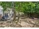 Landscaped backyard features a deck, stone details, and shady trees at 1028 Constitution Way, Cumming, GA 30040