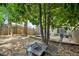 Shaded backyard features a fire pit area, stone landscaping, and views of the home at 1028 Constitution Way, Cumming, GA 30040