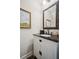 Elegant powder room with granite countertop, framed mirror and art adding character at 1028 Constitution Way, Cumming, GA 30040