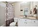 Well-maintained bathroom with a clean vanity, shower-tub combo, and decorative shower curtain at 1028 Constitution Way, Cumming, GA 30040
