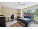 Large bedroom with carpet, a ceiling fan, and windows providing natural light at 1028 Constitution Way, Cumming, GA 30040