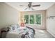 Bright bedroom with large windows offering scenic outdoor views and a comfortable bed at 1028 Constitution Way, Cumming, GA 30040