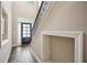 Bright foyer featuring hardwood floors, staircase with iron railing, and ample natural light at 1028 Constitution Way, Cumming, GA 30040