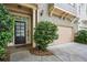 Inviting front entrance featuring a stylish door, garage, and well-maintained landscaping at 1028 Constitution Way, Cumming, GA 30040