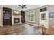 Cozy living room with a fireplace, built-in shelving, and large windows at 1028 Constitution Way, Cumming, GA 30040