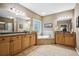 Elegant bathroom with double vanities, soaking tub, and tile flooring at 1028 Constitution Way, Cumming, GA 30040