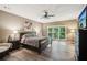 Spacious main bedroom with hardwood floors, a ceiling fan, and large bright windows at 1028 Constitution Way, Cumming, GA 30040