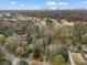 Aerial view showcasing the home, surrounding neighborhood, golf course, and city skyline at 1080 Clifton Ne Rd, Atlanta, GA 30307