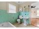 Turquoise bathroom with pedestal sink, tiled walls, and access to bedroom at 1080 Clifton Ne Rd, Atlanta, GA 30307