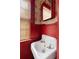 Small bathroom with vintage sink, red walls, and patterned wallpaper at 1080 Clifton Ne Rd, Atlanta, GA 30307