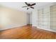 Spacious bedroom featuring hardwood floors, built-in shelving, and a ceiling fan with lighting at 1080 Clifton Ne Rd, Atlanta, GA 30307