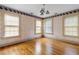 Bedroom featuring natural light, hardwood floors, and a stylish light fixture at 1080 Clifton Ne Rd, Atlanta, GA 30307