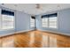Bright bedroom with wood floors, ceiling fan, and natural light from three windows at 1080 Clifton Ne Rd, Atlanta, GA 30307