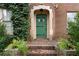 Close-up of the front door with stone archway and unique hardware at 1080 Clifton Ne Rd, Atlanta, GA 30307