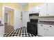 Charming kitchen with black appliances, checkered floors, and ample cabinet space at 1080 Clifton Ne Rd, Atlanta, GA 30307