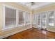 Bright living room features wood floors, large windows with blinds, and ceiling fan at 1080 Clifton Ne Rd, Atlanta, GA 30307