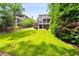 Expansive backyard with lush green lawn, mature trees, and a charming patio area, perfect for outdoor relaxation and entertainment at 1338 Iverson Ne St, Atlanta, GA 30307