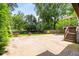 Concrete patio with landscaping and stair access to deck at 1338 Iverson Ne St, Atlanta, GA 30307