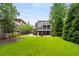 Spacious backyard featuring a well-maintained lawn, mature trees, and a private patio area for outdoor enjoyment at 1338 Iverson Ne St, Atlanta, GA 30307