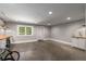 Spacious basement featuring concrete floors, a window, and built-in shelving for storage at 1338 Iverson Ne St, Atlanta, GA 30307