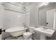 Bathroom featuring a claw foot tub, tiled walls and classic fixtures at 1338 Iverson Ne St, Atlanta, GA 30307