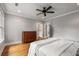 Bedroom with hardwood floors, dresser and walk-in closet and modern ceiling fan at 1338 Iverson Ne St, Atlanta, GA 30307