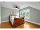 Bedroom with neutral walls, wood floors, ceiling fan and bright windows overlooking the yard at 1338 Iverson Ne St, Atlanta, GA 30307