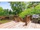 Wooden deck featuring a gas grill and wood railing overlooking lush landscaping at 1338 Iverson Ne St, Atlanta, GA 30307
