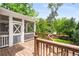 Wooden deck and staircase leading to a screened-in porch overlooking lush greenery at 1338 Iverson Ne St, Atlanta, GA 30307