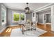 Bright dining room with hardwood floors, large windows, neutral paint, and a stylish light fixture at 1338 Iverson Ne St, Atlanta, GA 30307