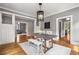 Traditional dining room featuring hardwood floors, white trim and paneled wainscoting with views to living areas at 1338 Iverson Ne St, Atlanta, GA 30307
