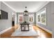 Elegant dining room with hardwood floors, large windows, neutral paint, and stylish light fixture at 1338 Iverson Ne St, Atlanta, GA 30307