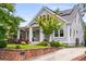 Attractive home with green lawn, brick retaining wall, charming front porch, and updated solar panels at 1338 Iverson Ne St, Atlanta, GA 30307