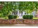 Charming home with lush landscaping, a brick retaining wall, and a welcoming front porch at 1338 Iverson Ne St, Atlanta, GA 30307