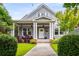 Charming home with a covered front porch, lush landscaping, and a well-maintained lawn at 1338 Iverson Ne St, Atlanta, GA 30307