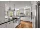 Bright kitchen with stainless appliances, double ovens, white cabinets, and large stainless farm sink at 1338 Iverson Ne St, Atlanta, GA 30307