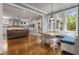 Open concept living room with dining nook, fireplace, built-ins, and hardwood floors at 1338 Iverson Ne St, Atlanta, GA 30307