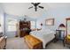 Cozy bedroom featuring carpet, a ceiling fan, and a desk with lamps and decorations at 418 Thaxton Ln, Woodstock, GA 30188