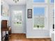 Bright entryway with a dutch door, hardwood floors, and abundant natural light from large windows at 418 Thaxton Ln, Woodstock, GA 30188