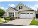 Charming one-story home with an attached two-car garage, well-maintained landscaping, and stone accents at 418 Thaxton Ln, Woodstock, GA 30188