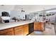 Bright, open kitchen with large island, hardwood floors, and easy access to living and dining areas at 418 Thaxton Ln, Woodstock, GA 30188